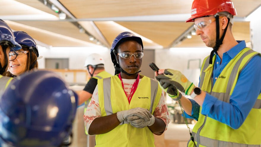 People wearing hard hats and high vis jackets talking
