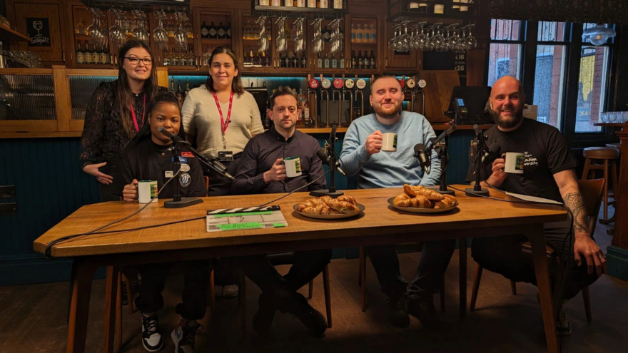 Renee with friends around a table at the podcast