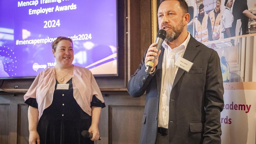 A photo of Mark talking at the award ceremony with Ciara next to him